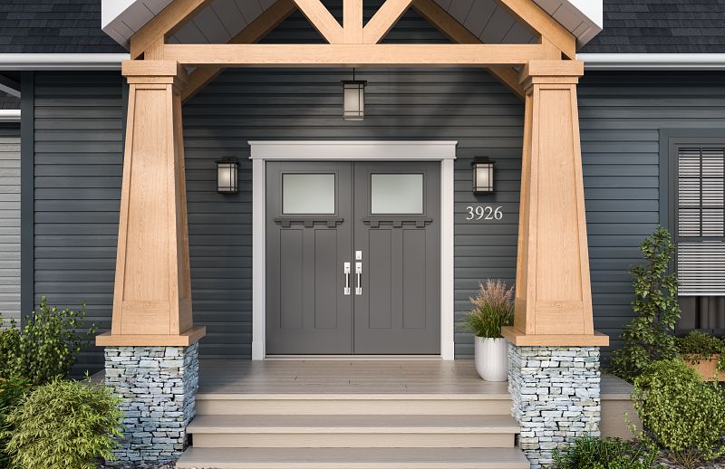 The outside of a craftsman-style home with black horizontal siding, wood porch columns and 2 panel quarter lite gray double front doors with dentil shelf