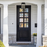 black 8 lite front door on a farmhouse home